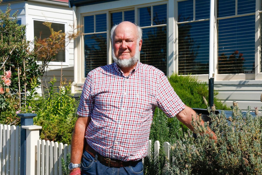 Emergency doctor Bryan Walpole stands in front of his garden