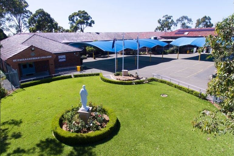 A school playground with a statue of Mary.