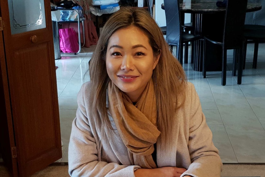 Pansy Leung sits at a table.