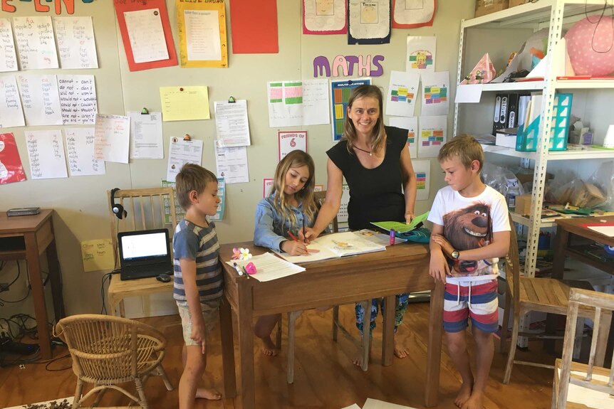 Mary Pharoah in the classroom at Amungee Mungee station with six-year-old Joe, nine-year-old Elise and eight-year-old Sam.