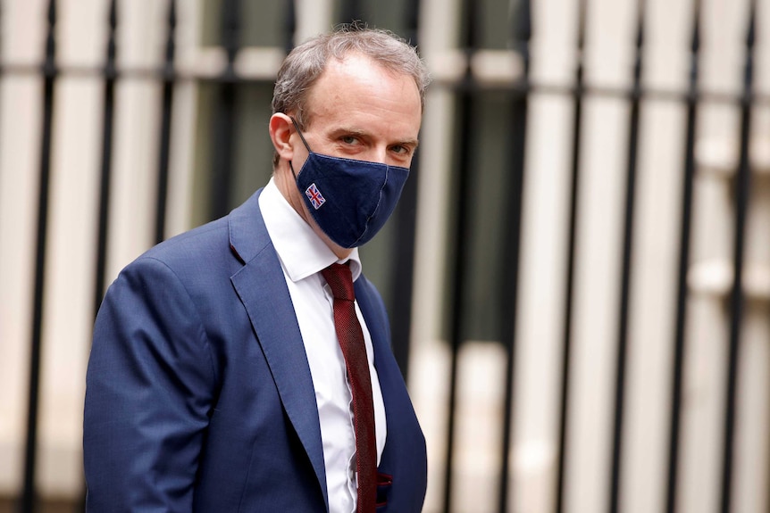 Britain's Foreign Affairs Secretary Dominic Raab wears a face mask