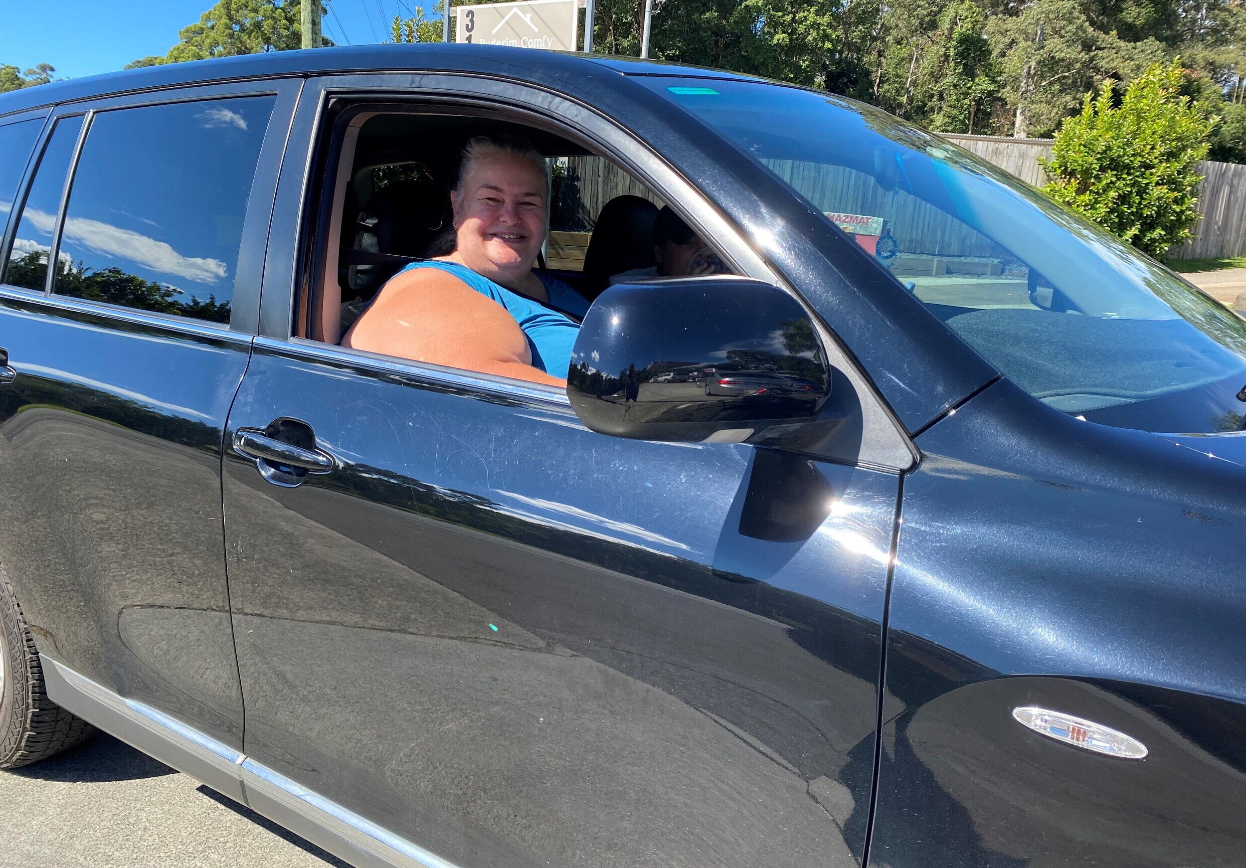 A woman in her car at a petrol station