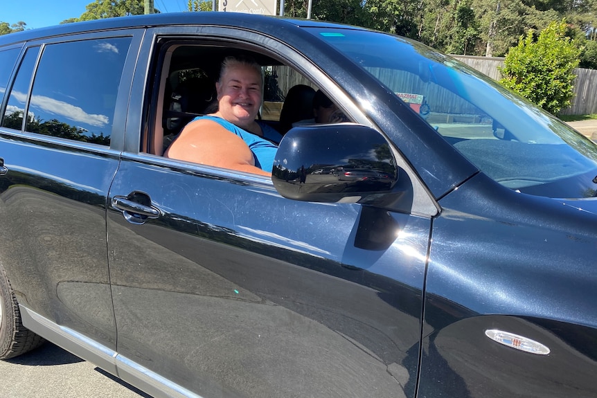 A woman in her car at a petrol station