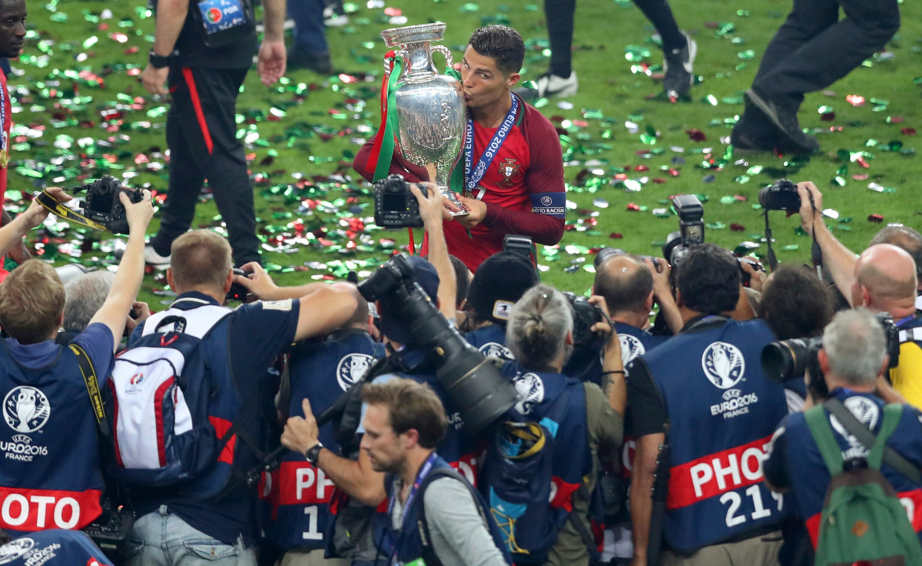Cristiano Ronaldo holds a trophy in front of camera