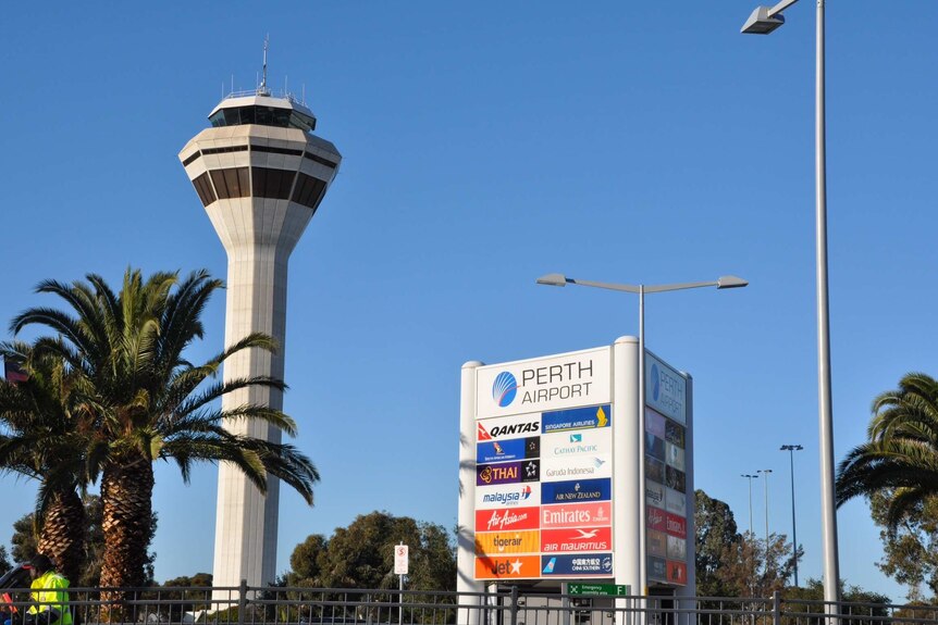 A wide shot of the airline board and traffic tower at Perth's international airport terminal.