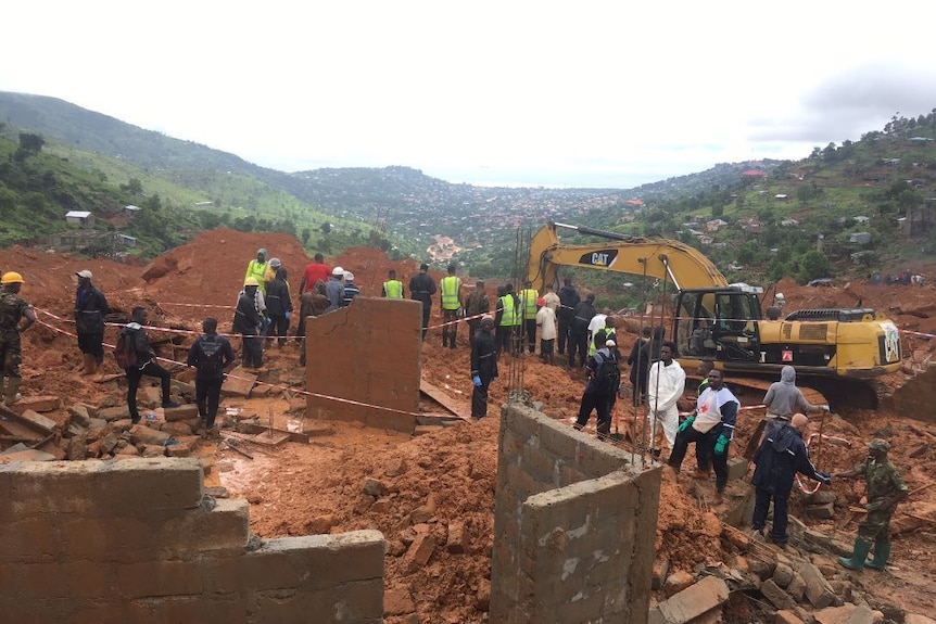 Emergency workers gather to assess the damage of the mudslide.