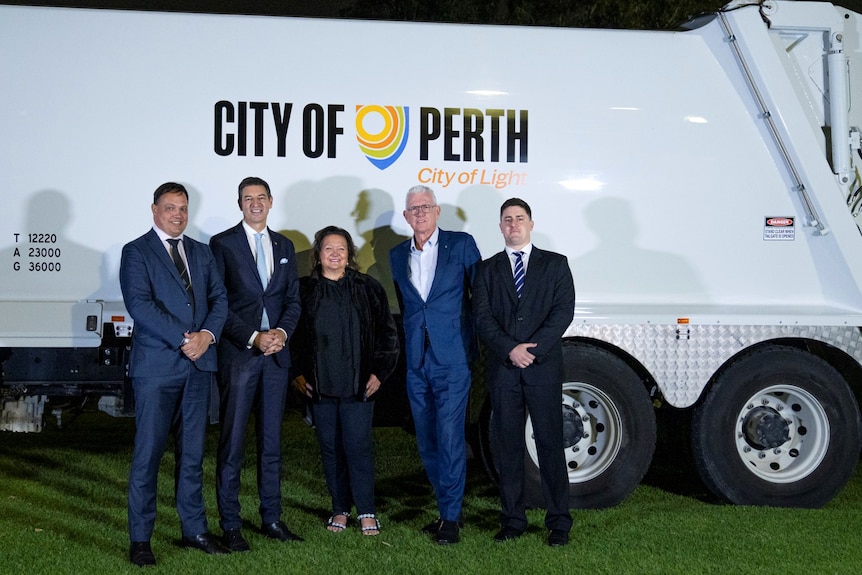 Five people stand in front of a City of Perth rubbish truck