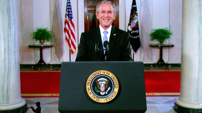 Laura Bush, bottom left, applauds as her husband President George W Bush
