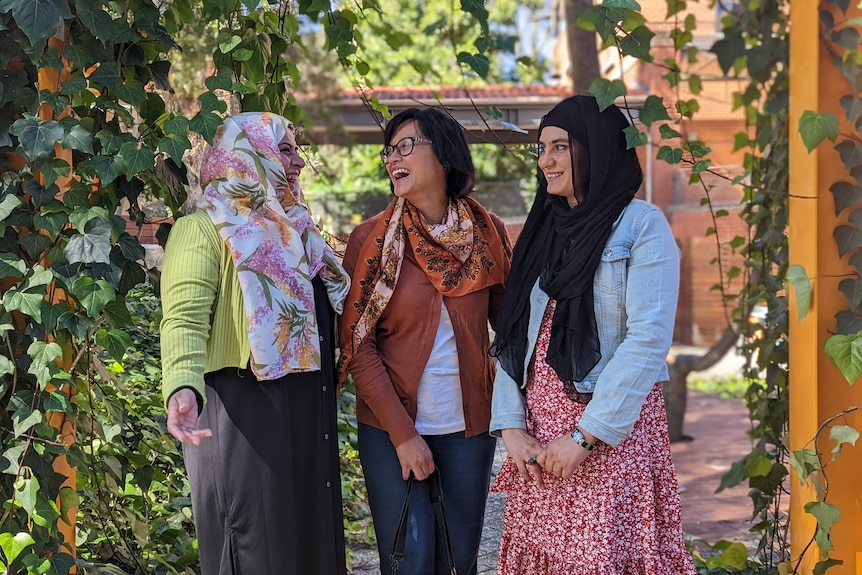 Sobia Shah, Yuridyah Mulyadi and Anam Irshad pictured smiling and laughing in a garden