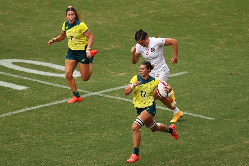 A woman wearing yellow top runs away from another woman wearing a white top