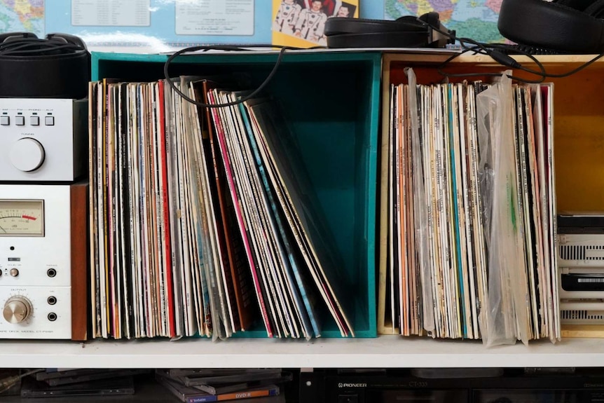Containers of records line a wall in Tony Hutchison's home radio shack.