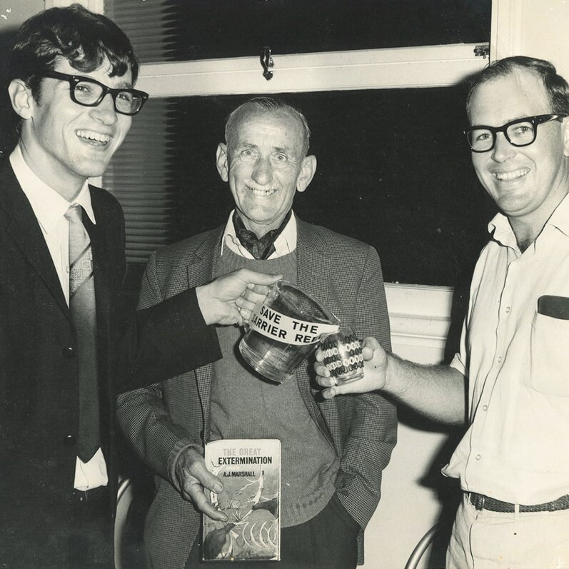 Black and white photo of Eddie Hegerl (left) and John Büsst (centre), unknown man on right, campaigning in Innisfail.