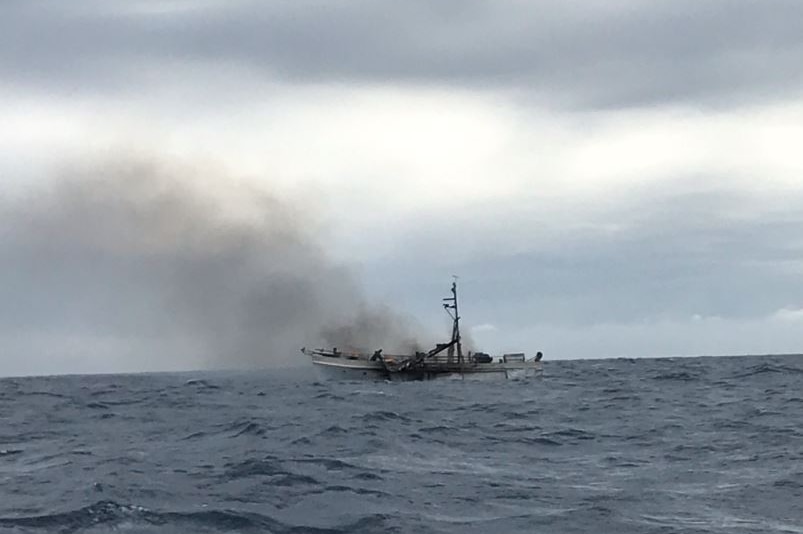 Smoking remnants of a charter boat that caught fire off Gladstone.