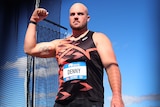 Matt Denny clenches his fist after a national record-breaking throw