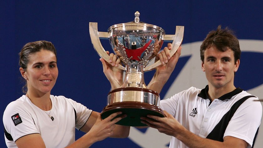 To the victors go the spoils: Martinez Sanchez and Robredo hold the Hopman Cup trophy high.