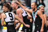 Four Port Adelaide Power AFL players celebrate the scoring of a goal against Richmond.