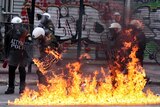 A petrol bomb explodes at riot police during a 48-hour general strike in Athens.