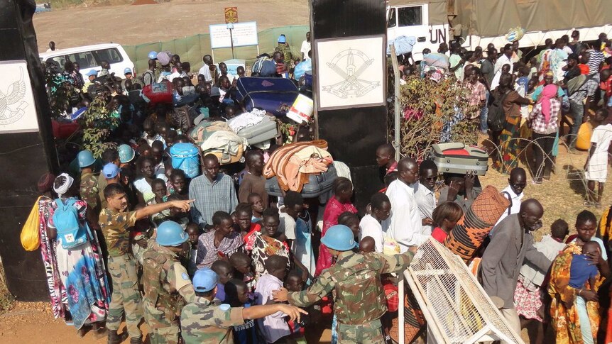Civilians gather outside the UN compound in Juba