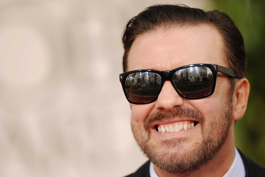 Ricky Gervais arrives at the Golden Globe Awards wearing sunglasses.