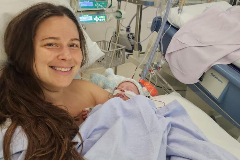 Baby Menasheh and his mum cuddle in hospital