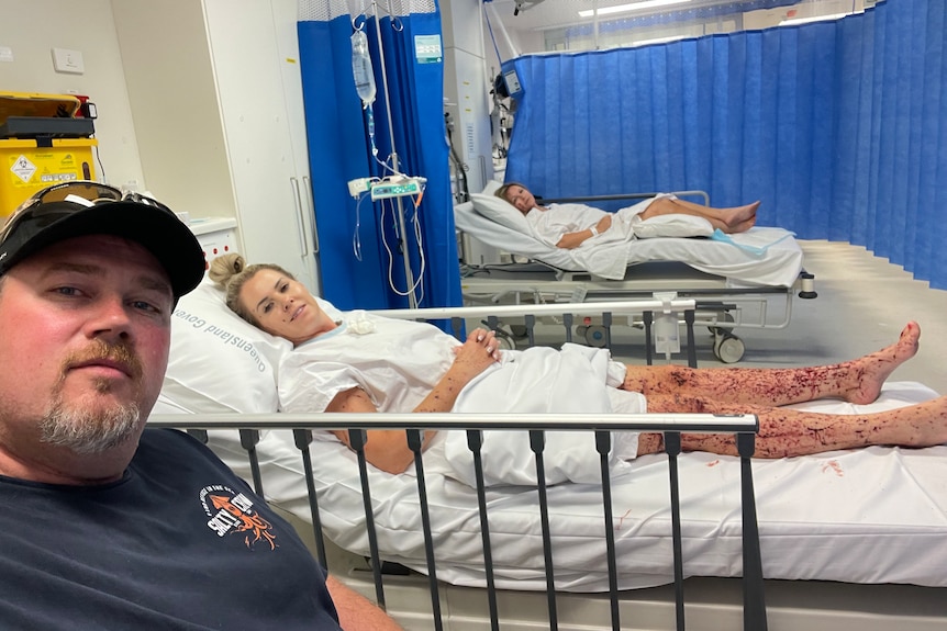 Marle and Edward Swart and Elmarie Steenberg lie in hospital beds with bloodied legs.