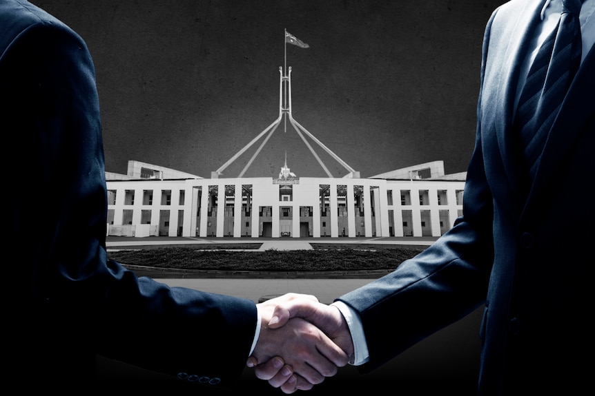 Two men in suits shaking hands, with Parliament House in black and white in the background.
