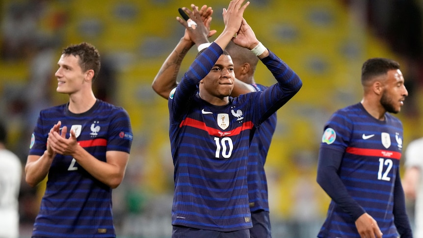 Kylian Mbappe applauds the French fans