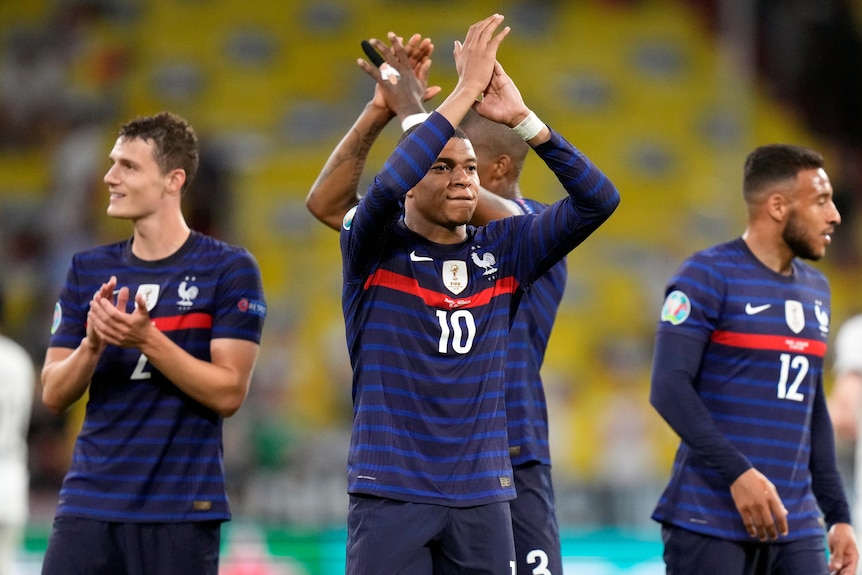 Kylian Mbappe applauds the French fans