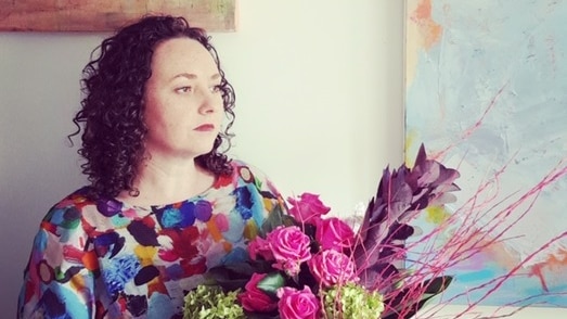 Canberra floral artist Narelle Phillips holding one of her artworks. Aug 2020.