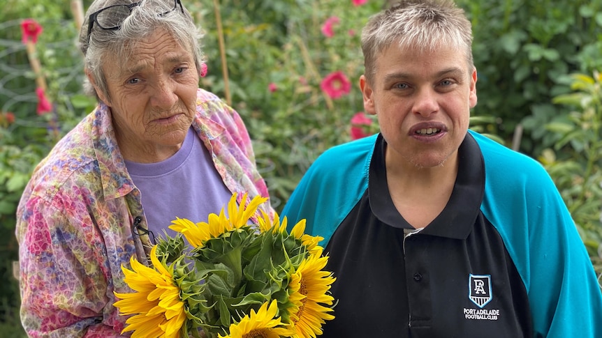 Two ladies standing with flower bouquet 