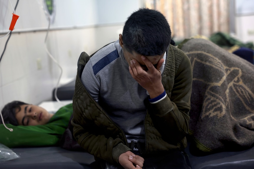 Earthquake victims receive treatment at the al-Rahma Hospital in the town of Darkush, Idlib province, northern Syria