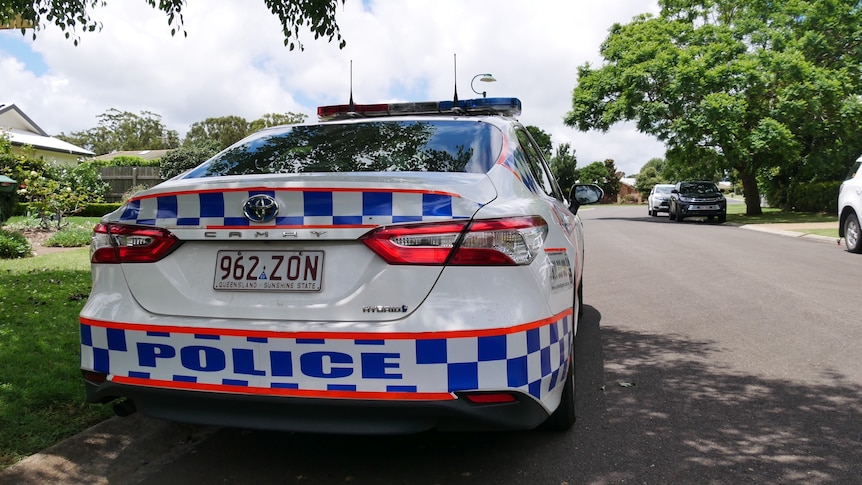 A police car on a suburban street.