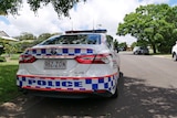 A police car on a suburban street.