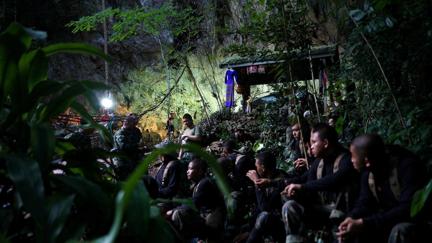 Military personnel at the entrance to a Thai cave where a soccer team remains trapped