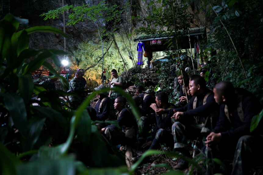 Military personnel at the entrance to a Thai cave where a soccer team remains trapped