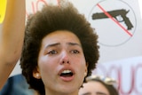A protester weeps while chanting at a rally.
