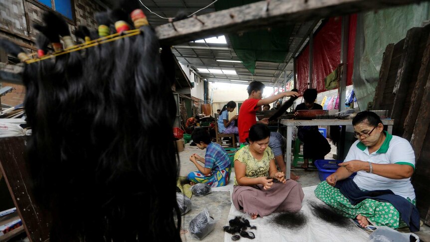 Workers clean the hair for export at Tet Nay Lin Trading Co