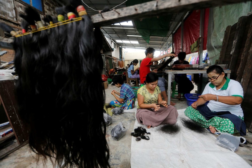 Workers clean the hair for export at Tet Nay Lin Trading Co
