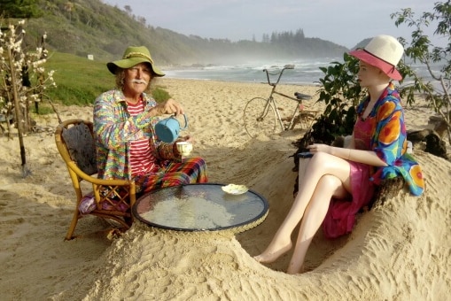Rick Thomson-Jones sitting with one of his quirky beach creations.