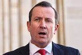 WA Premier Mark McGowan, speaking at a press conference outside parliament, mouth open, mid speaking