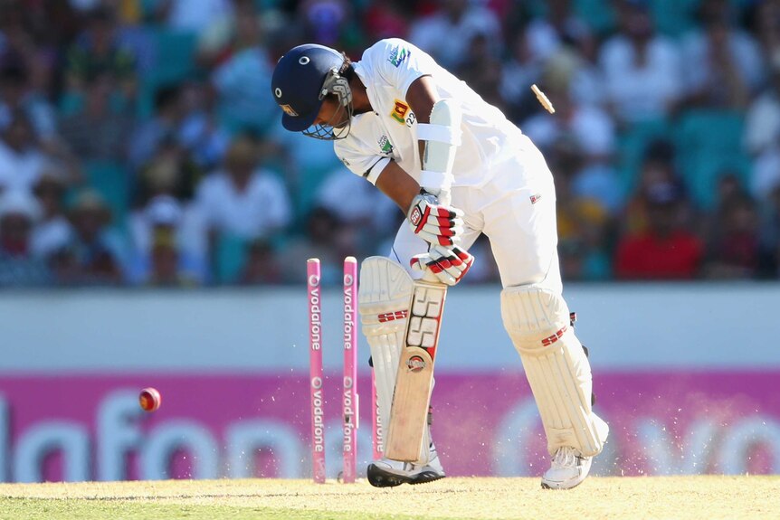 Bowled him ... Dinesh Chandimal gets cleaned up by Mitchell Starc.