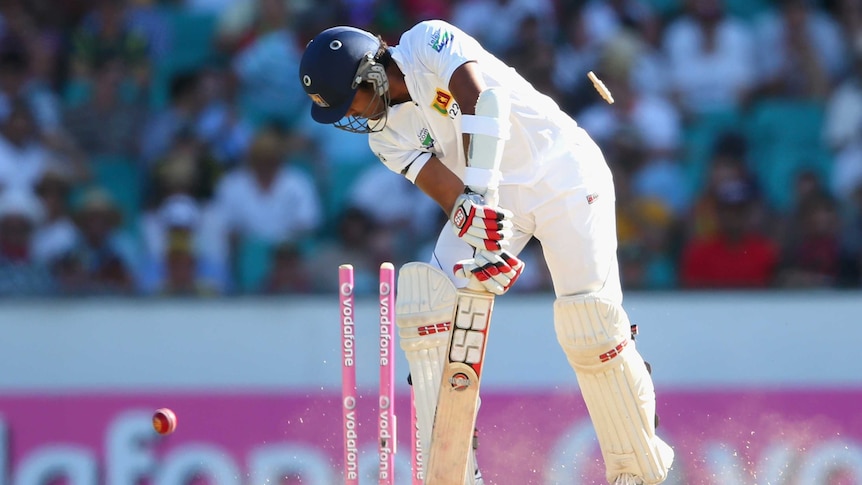 Bowled him ... Dinesh Chandimal gets cleaned up by Mitchell Starc.