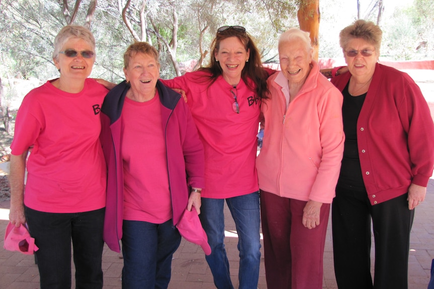 group of middle aged women dressed in pink