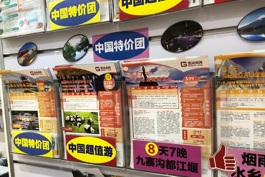 Travel deals to China on pamphlets, written in Chinese characters