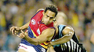 Andrew McLeod of the Crows clashes with Shaun Burgoyne of Port Adelaide