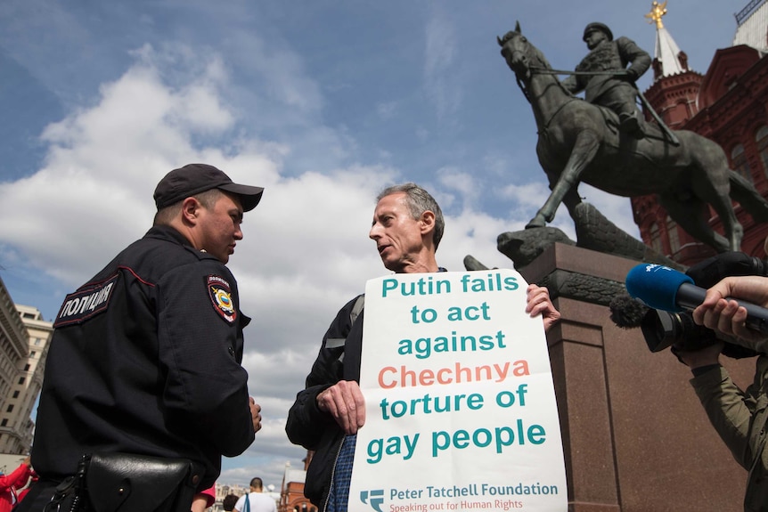 Tatchel, holding his protest sign "Putin fails to act against Chechnya torture of gay people"