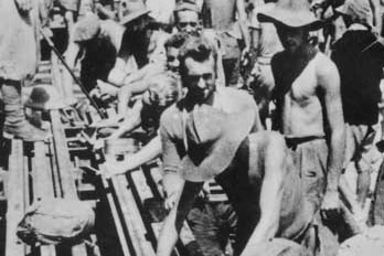 A black and white photo of prisoners of war working on the Thai-Burma Railway.