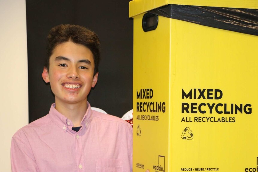 Heywire act 2022 winner Joji holds a recycling bin
