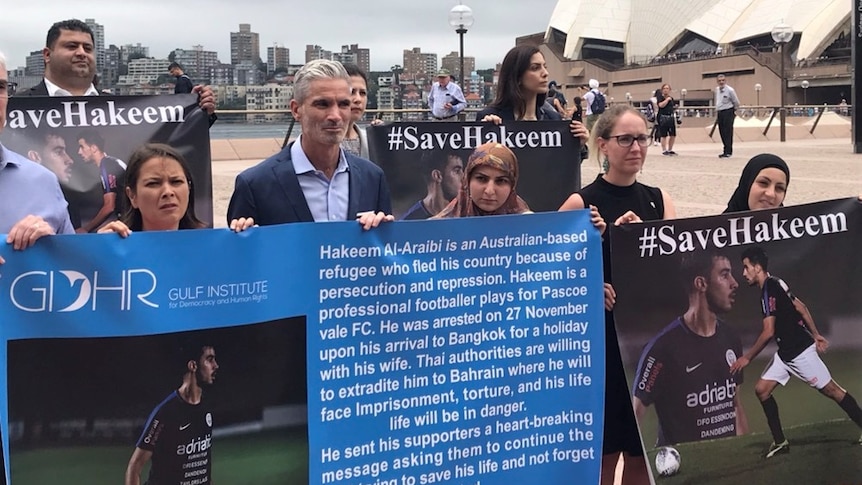Former Socceroo Craig Foster (centre) and human rights groups held a demonstration in front of the Sydney Opera House.