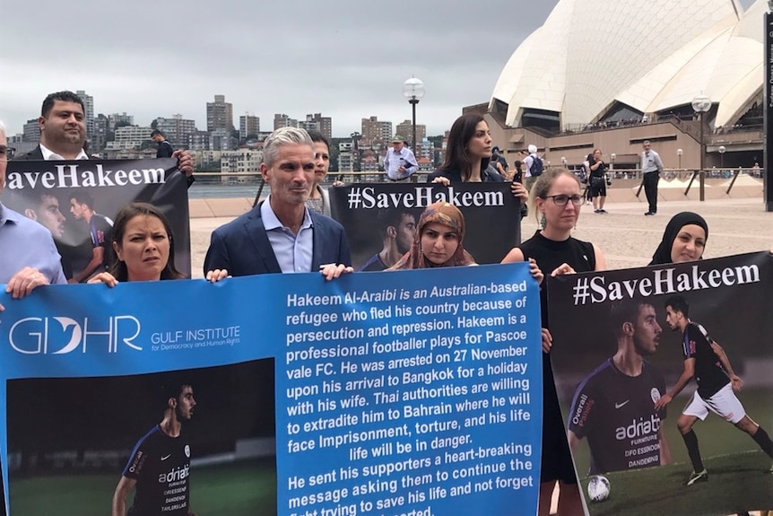 Former Socceroo Craig Foster (centre) and human rights groups held a demonstration in front of the Sydney Opera House.